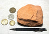 sandstone  -  teaching hand/display specimen of the Navajo Sandstone, a fine-grained orange-pink aeolian sandstone