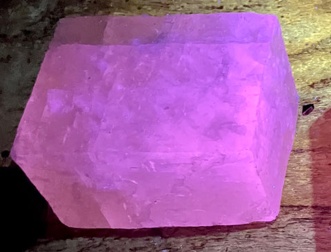 calcite - cool pink fluorescent and phosphorescent calcite cleavage rhomb from the Challenger Cave system, Nuevo Leon, Mexico
