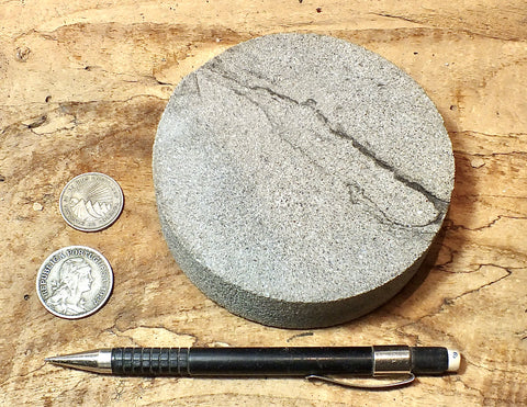 sandstone - medium grained gray - 4" diameter oil well core slice from the Stevens Sand - hand specimen