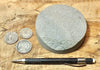 sandstone - medium grained gray - 4" diameter oil well core slice from the Stevens Sand - hand specimen
