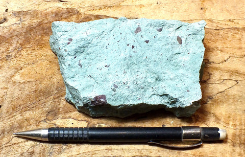 tuff - copper-stained green welded tuff - teaching hand specimen