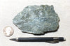 talc - clinochlore soapstone - a dark green talcose mineral - teaching hand specimen