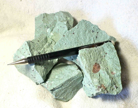 tuff - copper-stained green tuff with numerous clasts of pumice and other rock types - UNIT OF 5 student specimens 